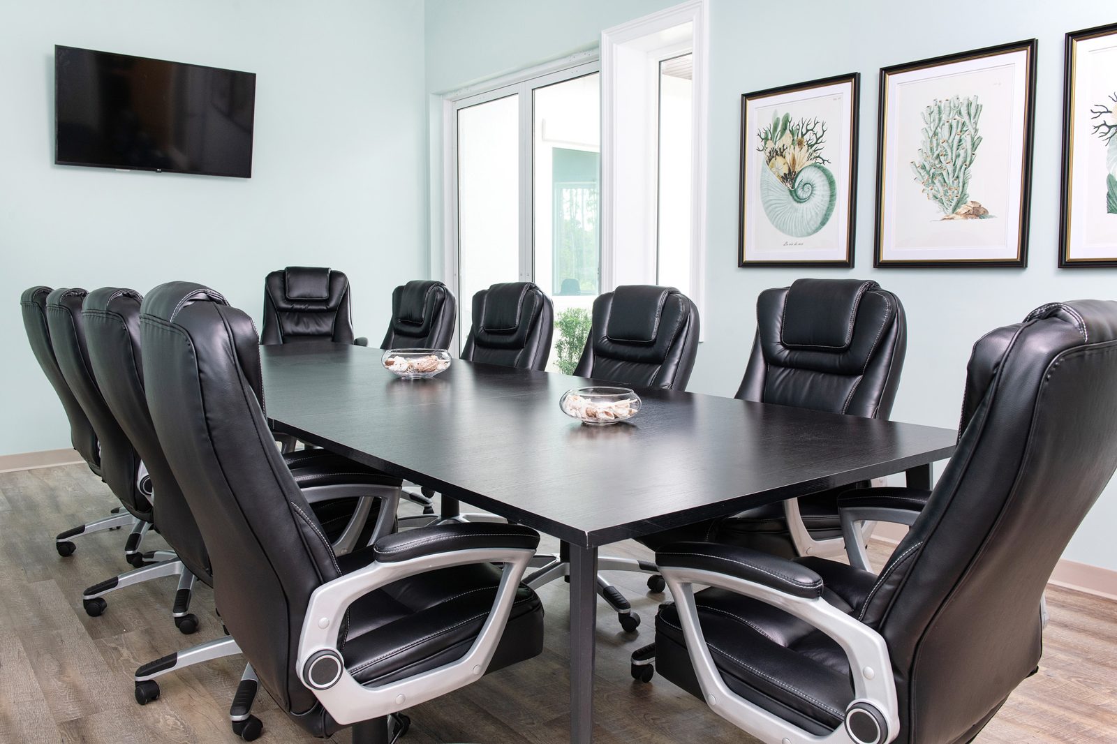 Large team meeting space with wall-mounted display