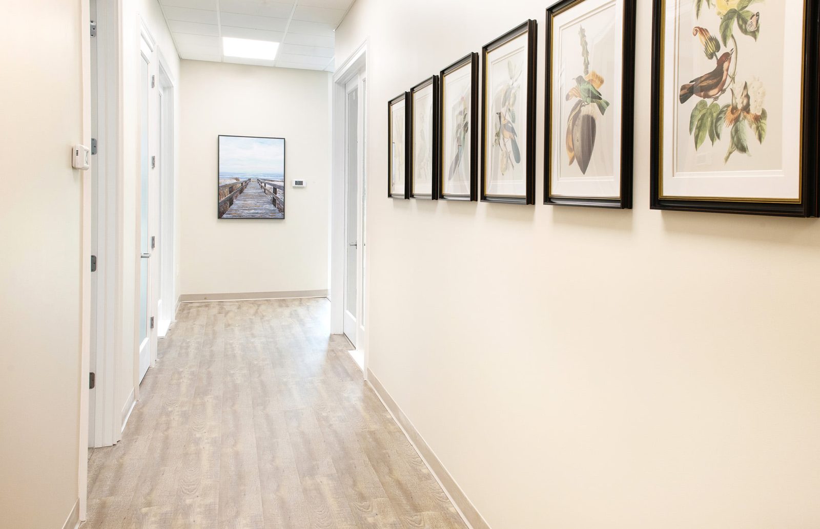 Bright gallery hallway leading to private suites