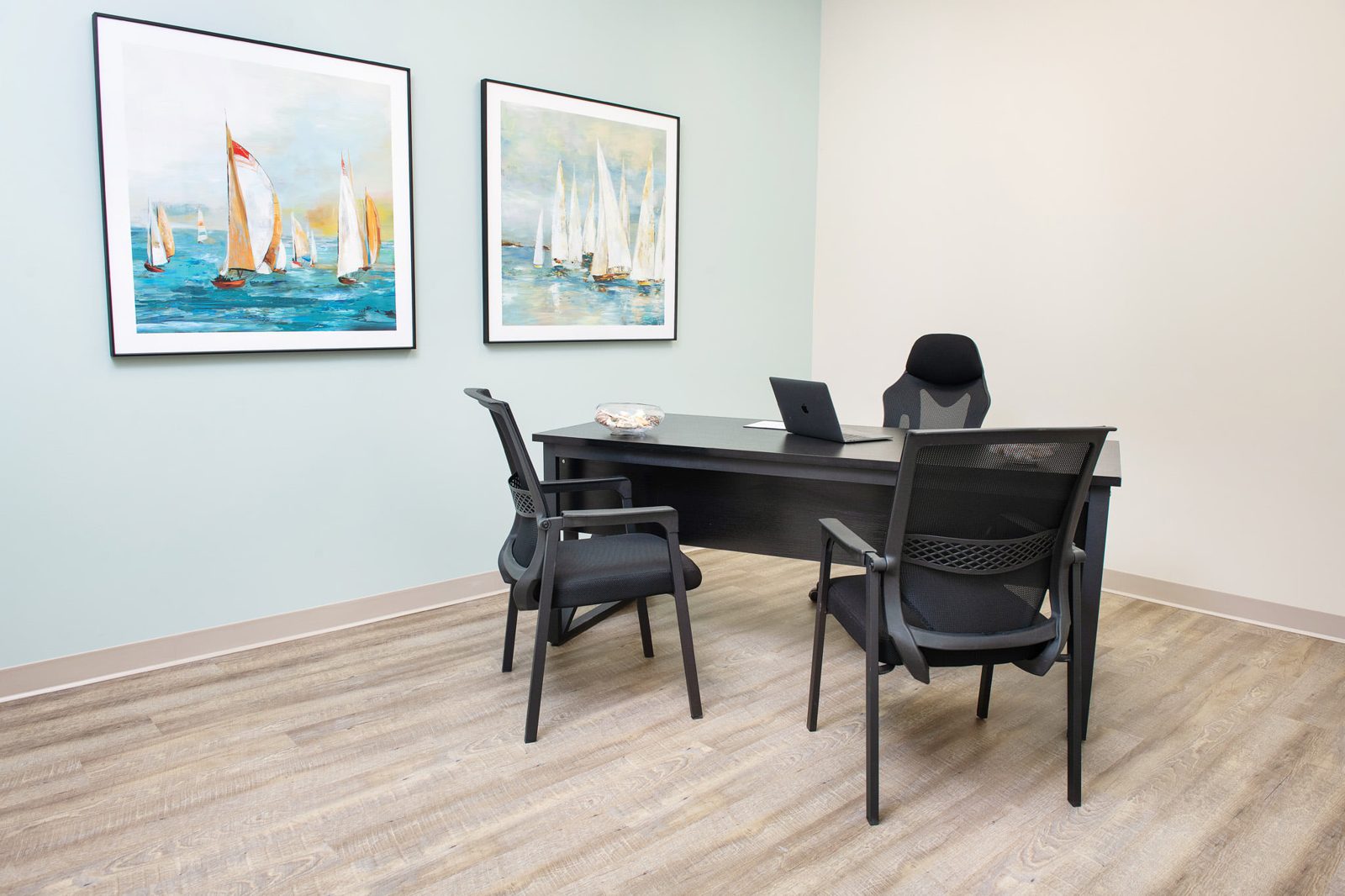 Furnished interior private office with sailboat artwork