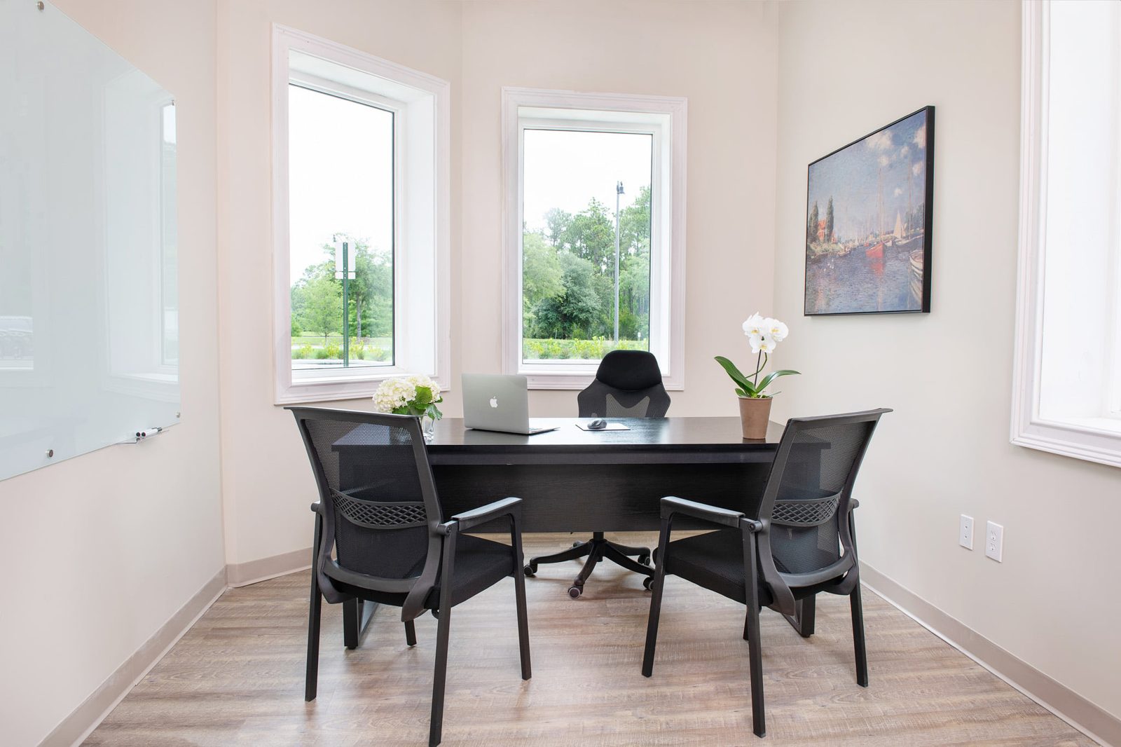 Furnished private office with two windows overlooking the Nocatee preserve